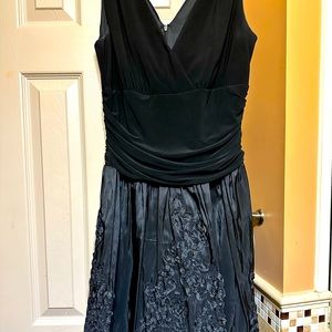 Black formal gown with floral embroidery throughout skirt